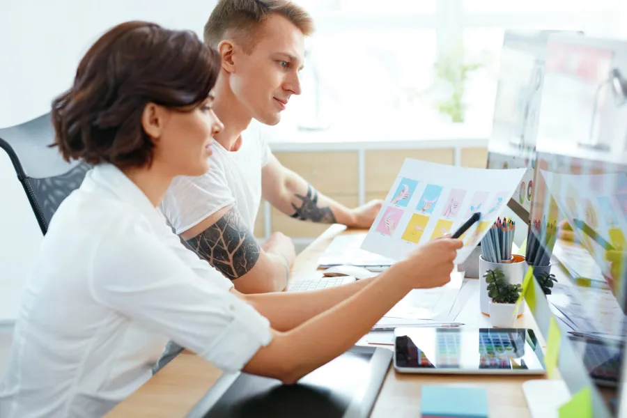 A Graphic Design team checking over a Print Layout