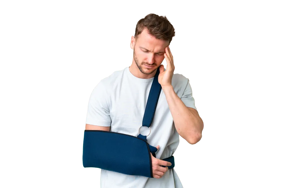 Man in white shirt with blue arm sling holding his head in pain, injured arm support and discomfort expression
