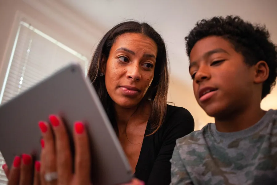 a man and a woman looking at a tablet