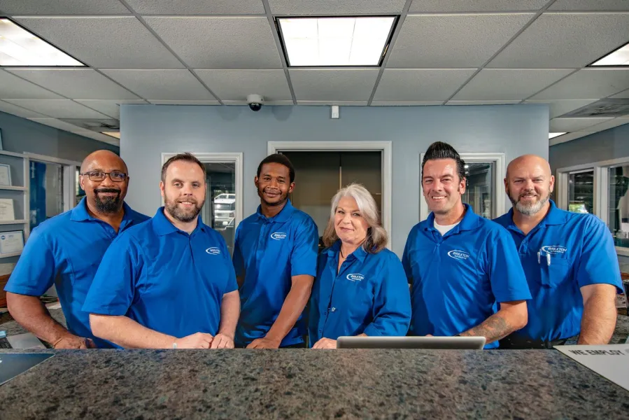 the Braxton Automotive team smiling at the camera