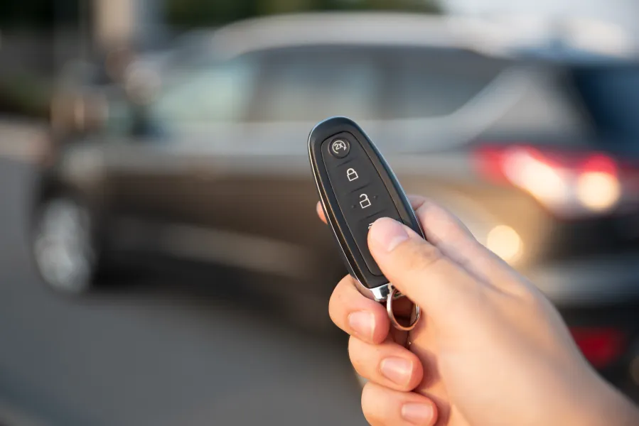 a person unlocking their car with a remote