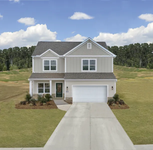 Modern two-story house with a manicured lawn and clear blue sky background.