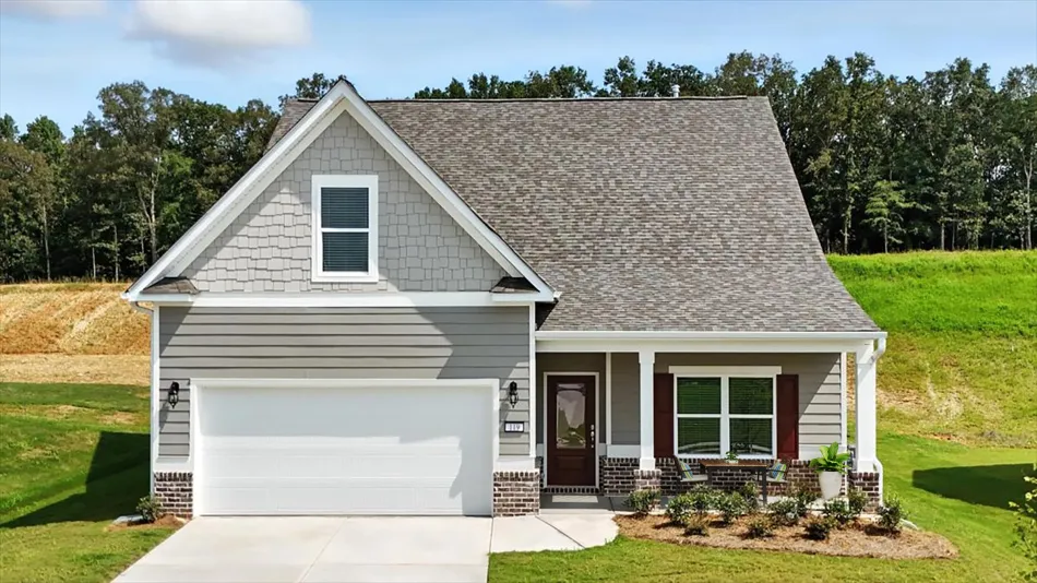 a house with a driveway and trees