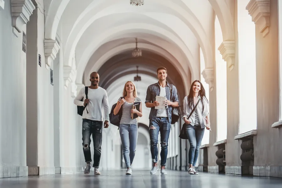 a group of people posing for a photo in a hallway