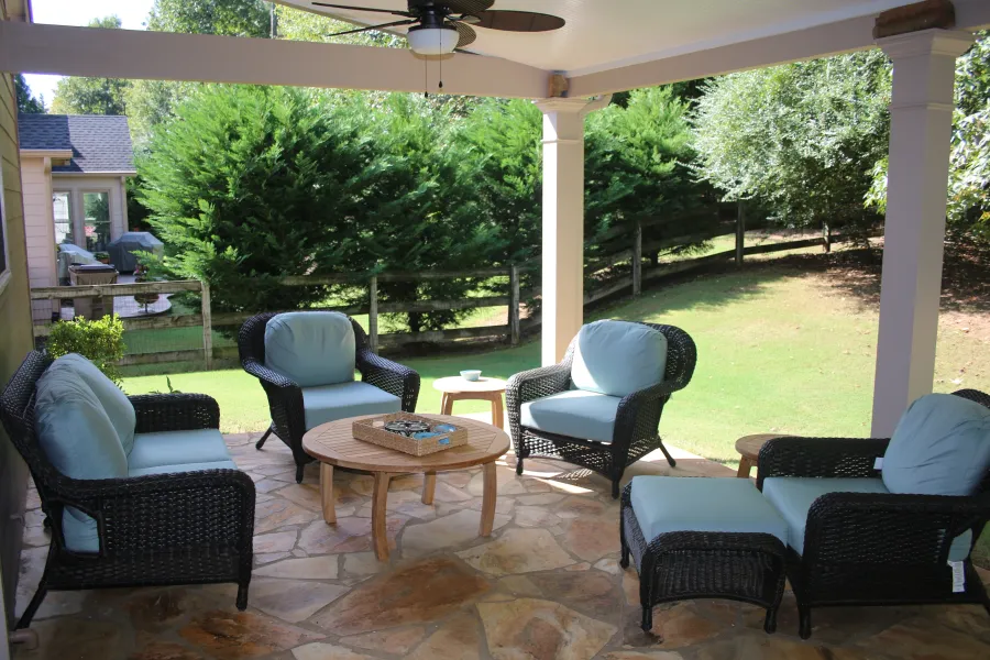 a patio with chairs and a table