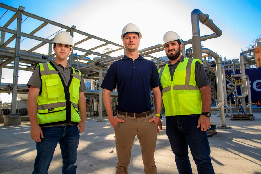 a group of men wearing safety vests
