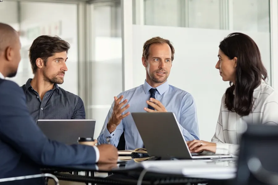 a group of people sitting at a table talking
