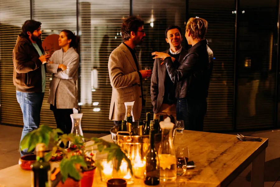 a group of people sitting at a table with wine glasses