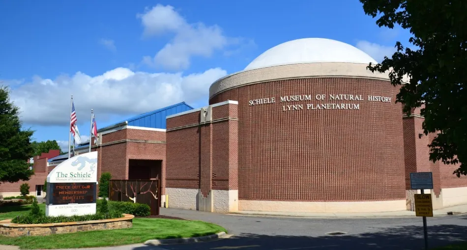 a large brick building with a flag on top