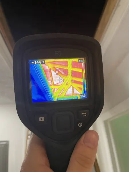 a person holding an infrared scanner