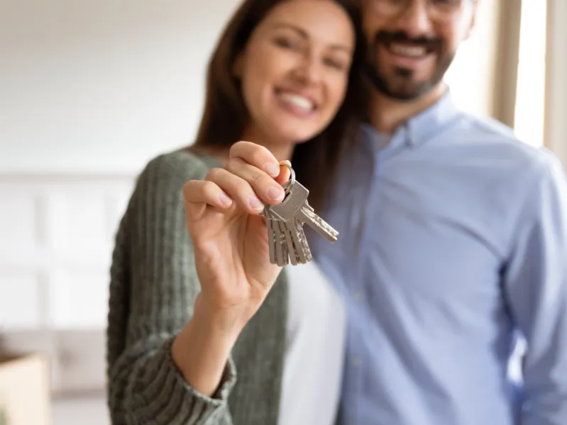 a woman holding house keys