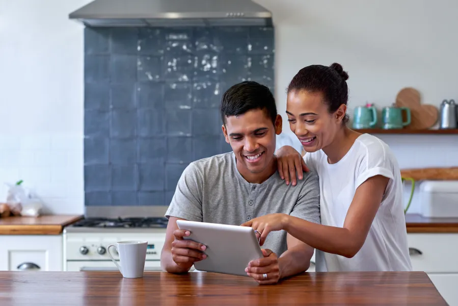 a man and a woman looking at a tablet