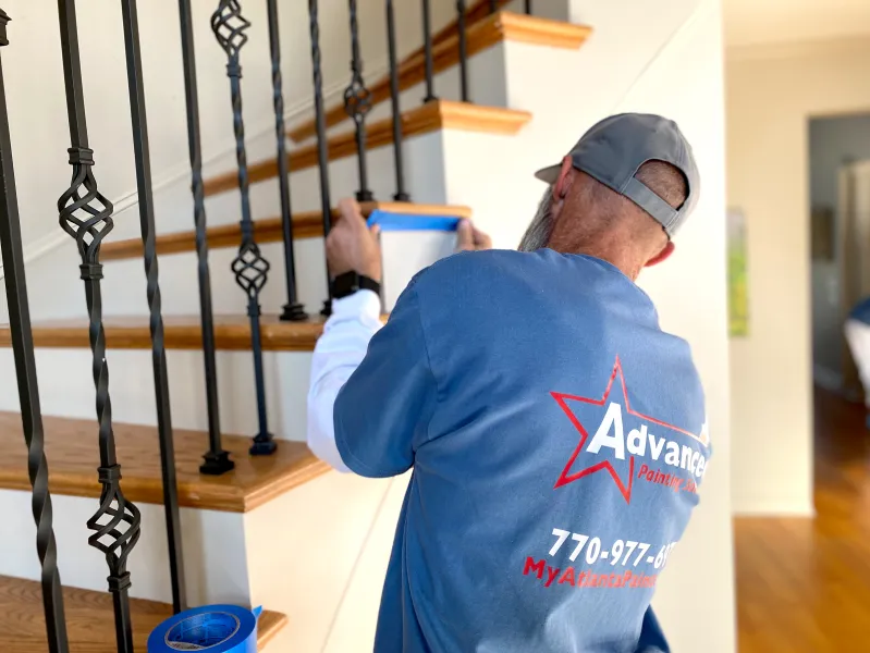 a man painting a staircase
