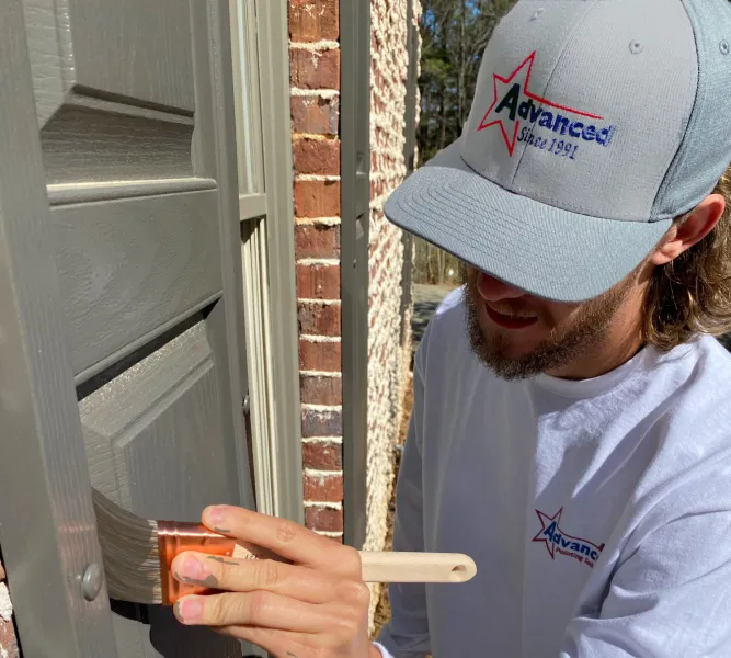 a man painting a shutter