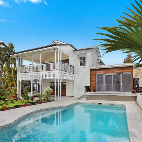 a large white house with a pool