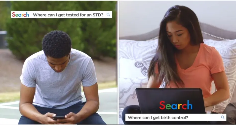 a group of people looking at a laptop