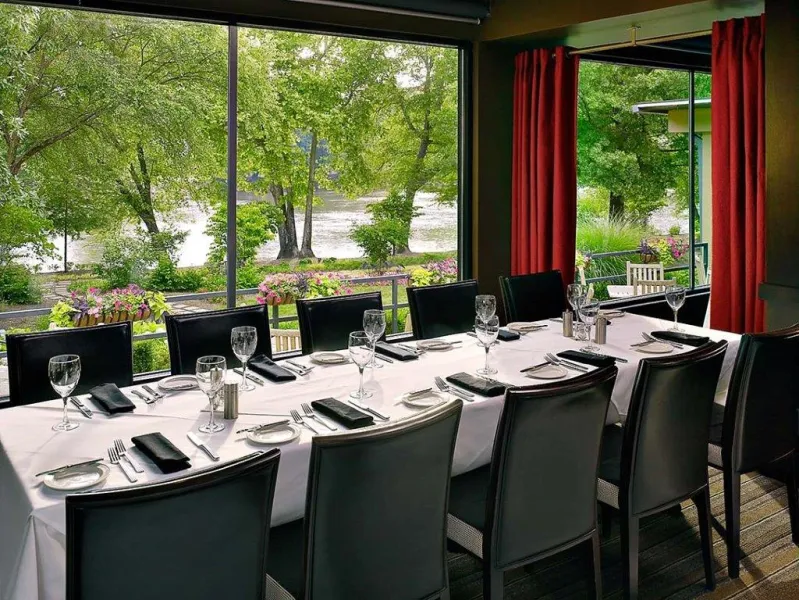 a dining room table in front of a window