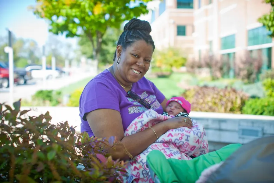 Valerie James holding a baby
