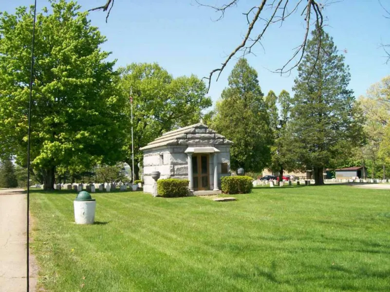 a large lawn in front of a tree