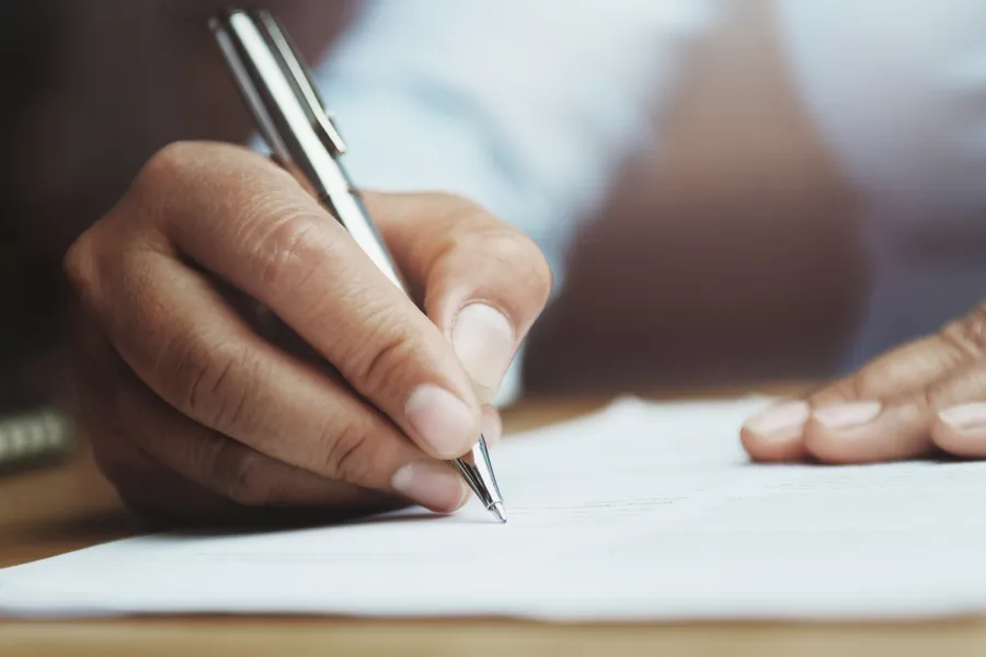 a hand holding a piece of paper