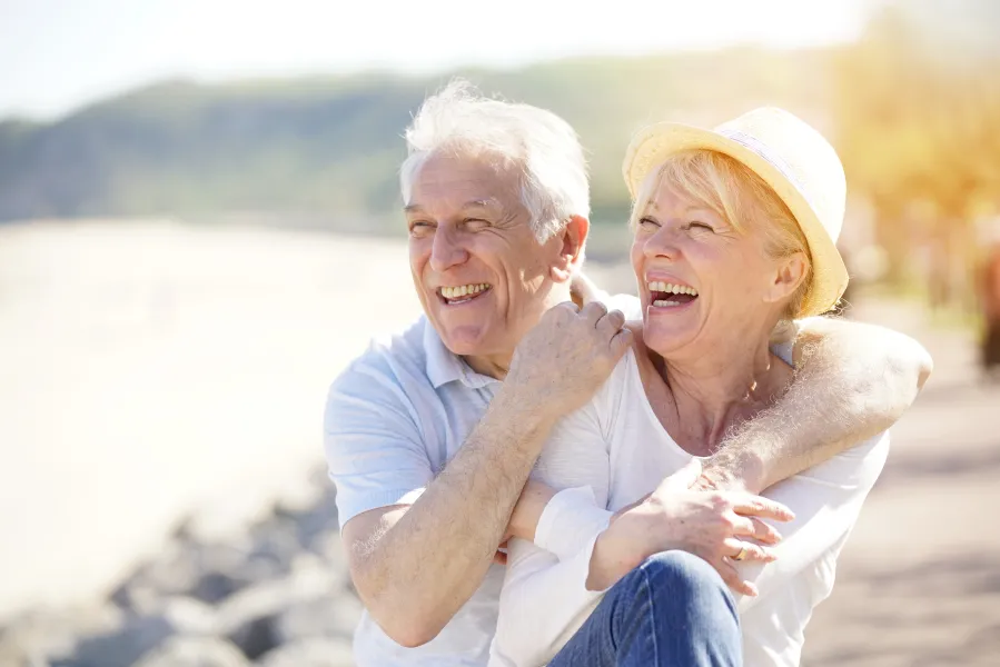 a man and a woman smiling for the camera