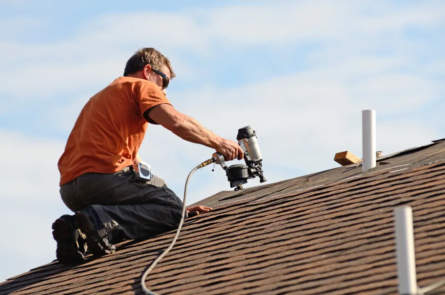a man using a camera on a roof
