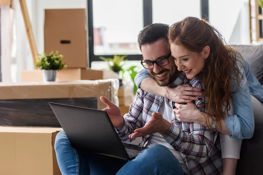 a man and a woman looking at a laptop