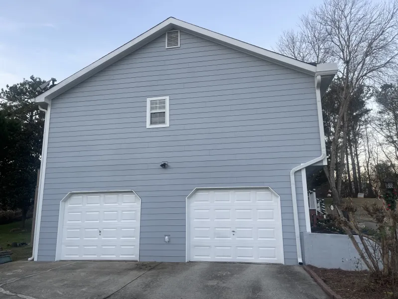 a grey house with garages