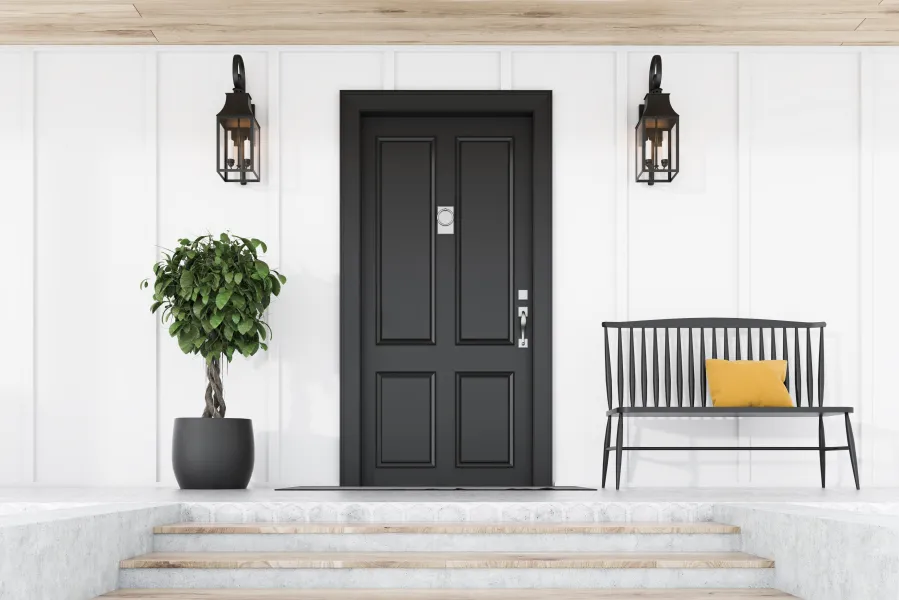a black door with a plant in front of it