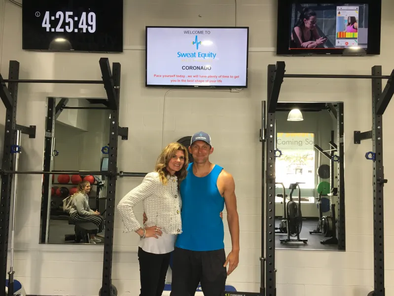 a man and a woman standing in front of a store