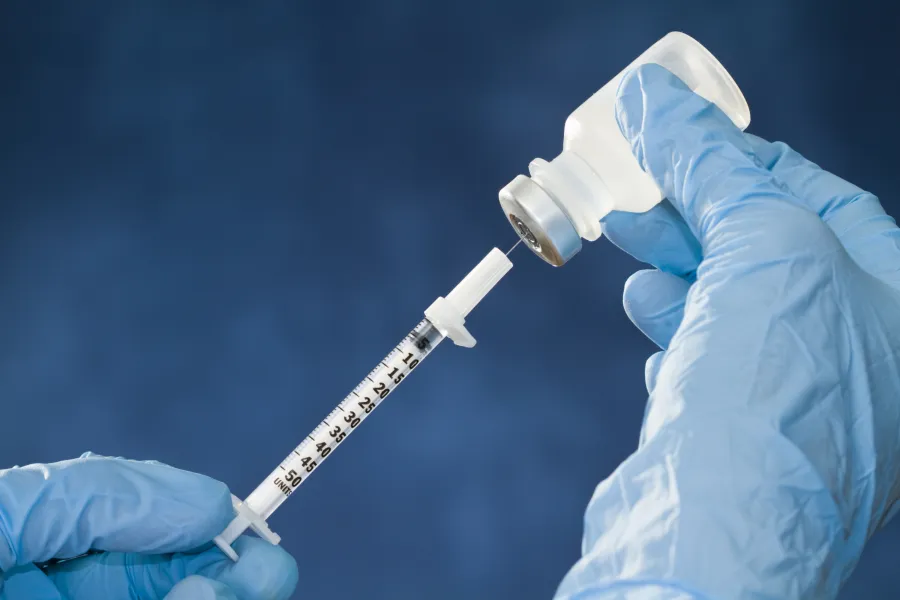 a person holding a syringe