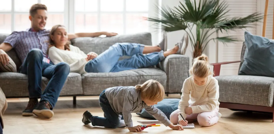 a group of people sitting around a living room