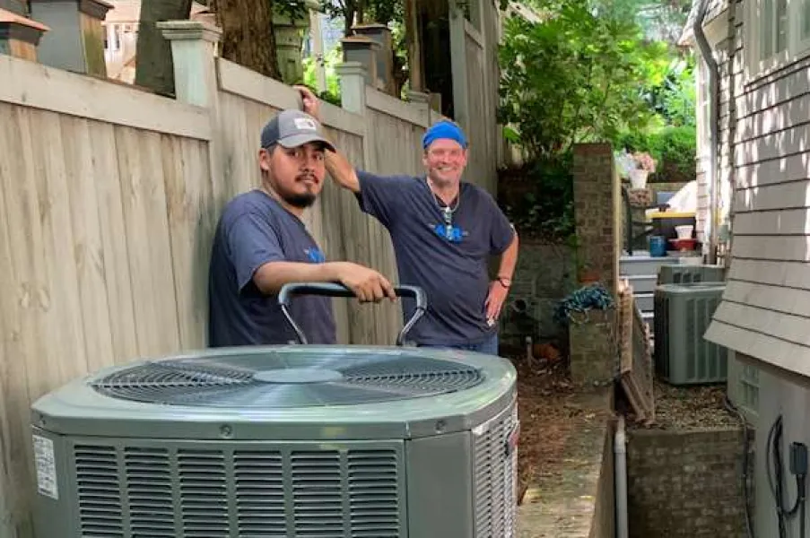 two hvac technicians installing a new system