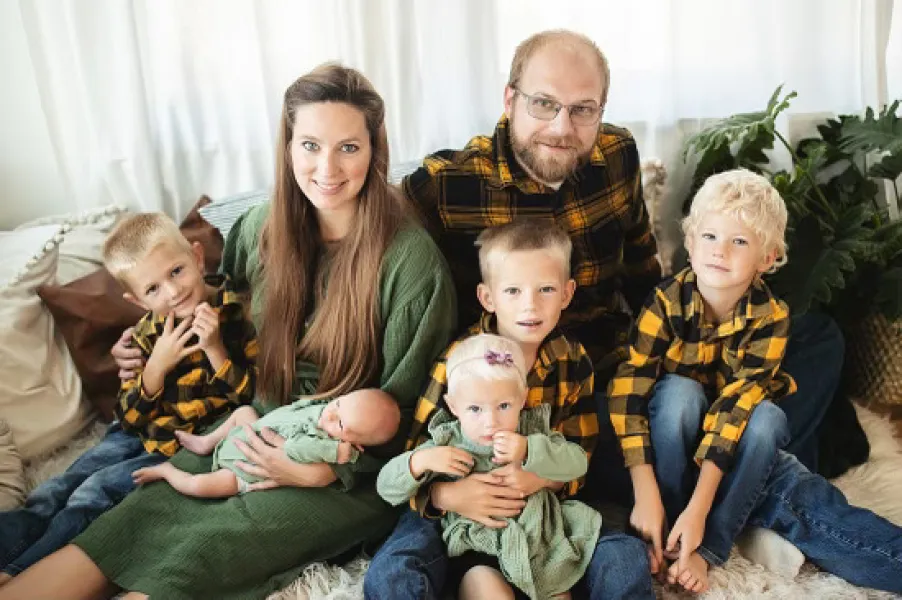a family sitting on a couch