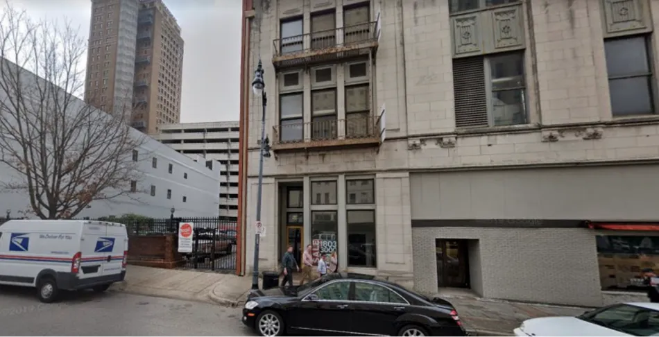 a building with a street and cars