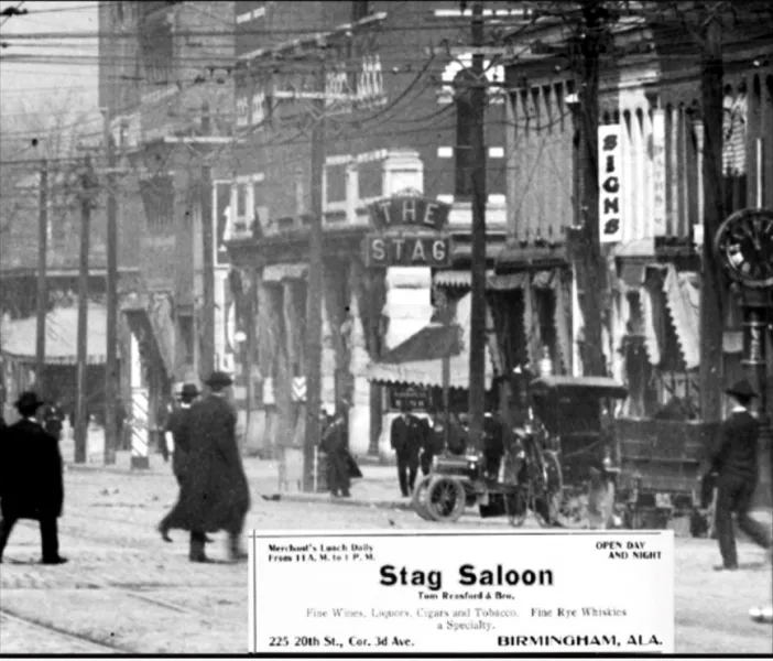 a black and white photo of a street with people and buildings