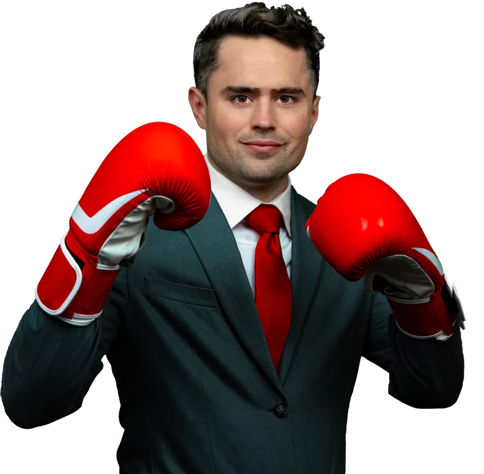 a man wearing a suit and red tie with boxing gloves