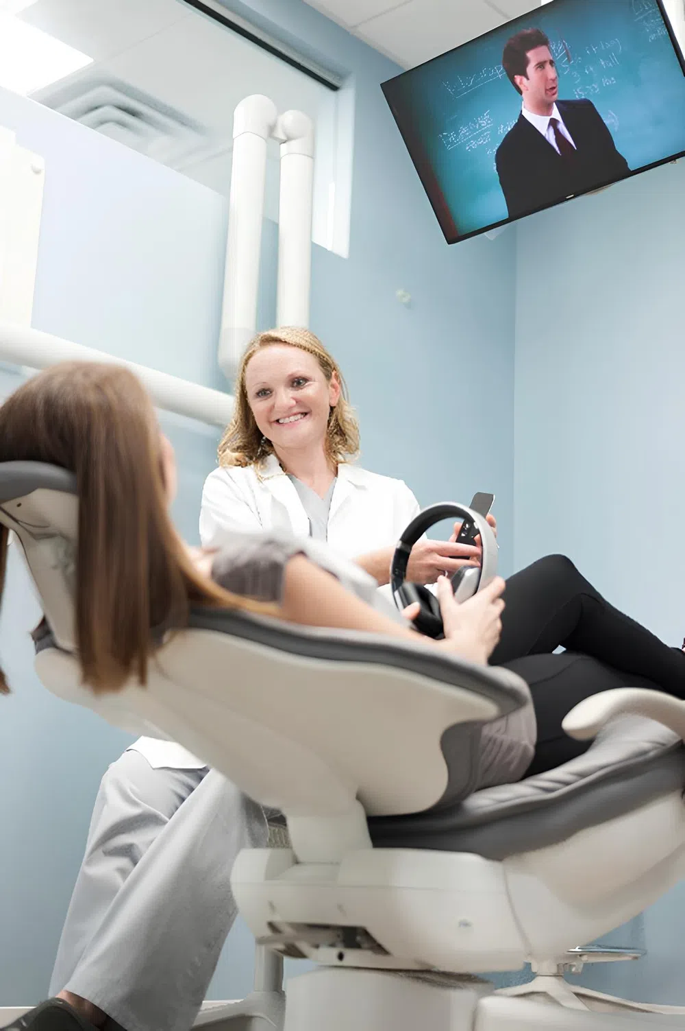 Dentist smiling while consulting a patient