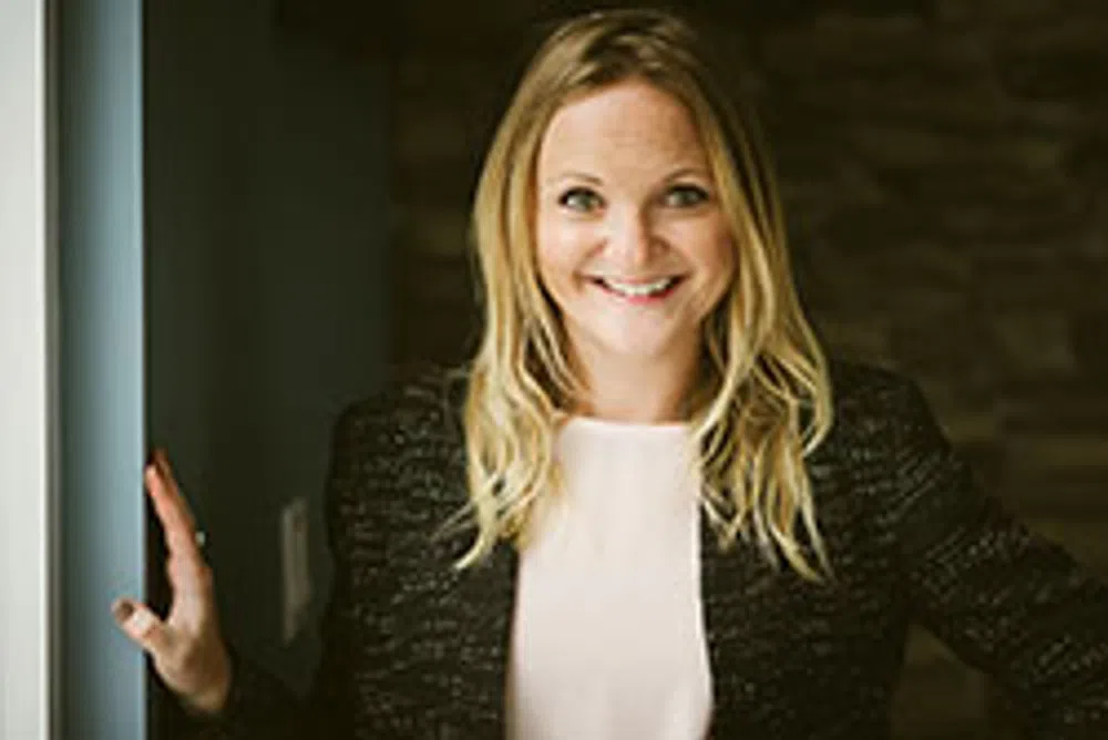Smiling blonde woman wearing a black jacket