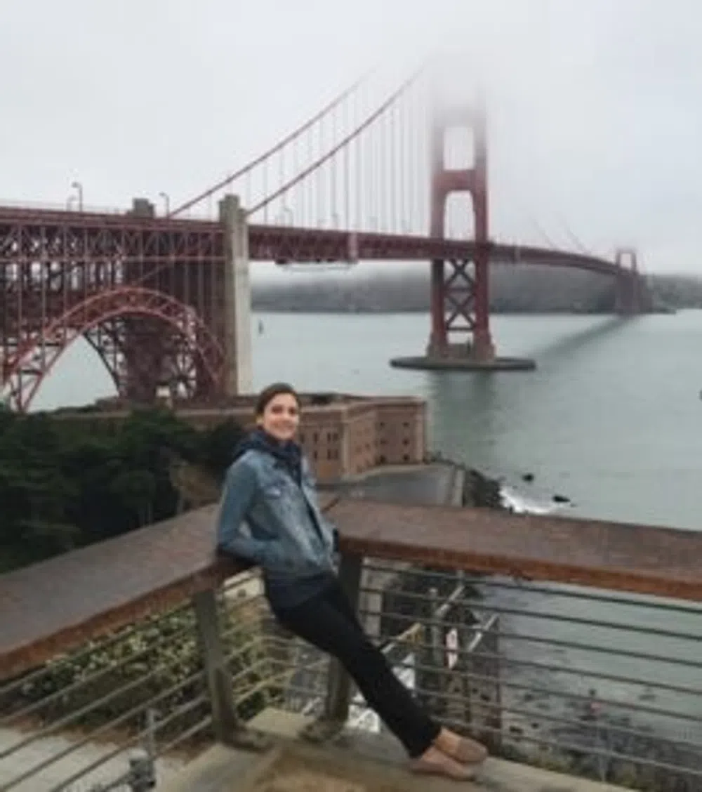 Person leaning on railing with foggy 