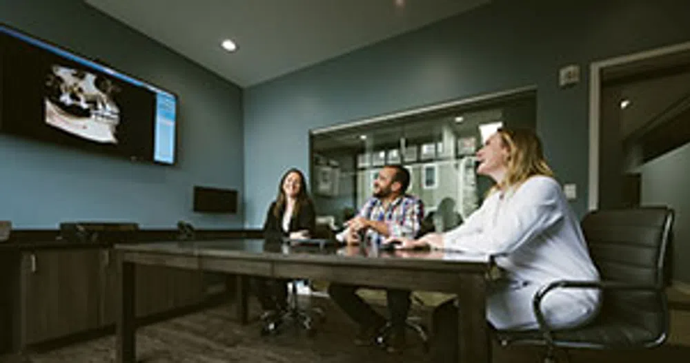 Three professionals in a meeting room
