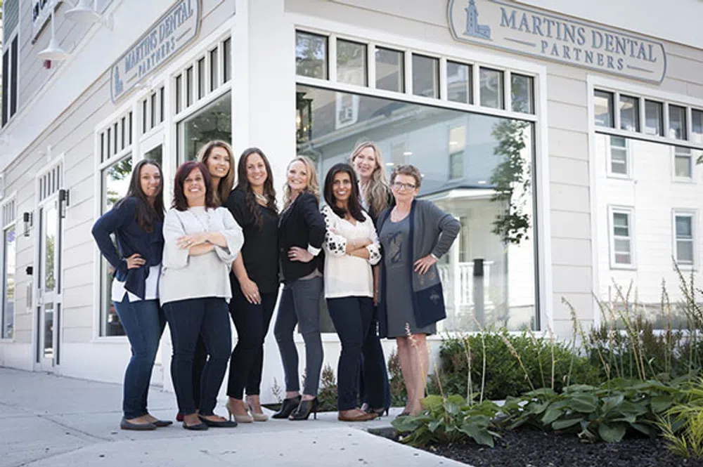 Group of seven dental professionals standing outside Martins Dental Partners office
