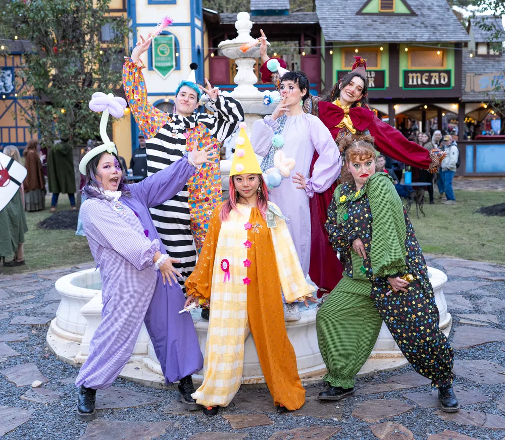 The Fool and laughing guests in bright motley at the Feast of Fools on Saturday, November 14