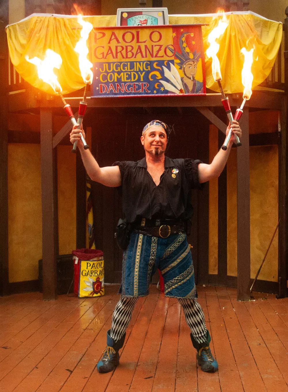 Paolo Garbanzo juggling four lit torches at Georgia Renaissance Festival