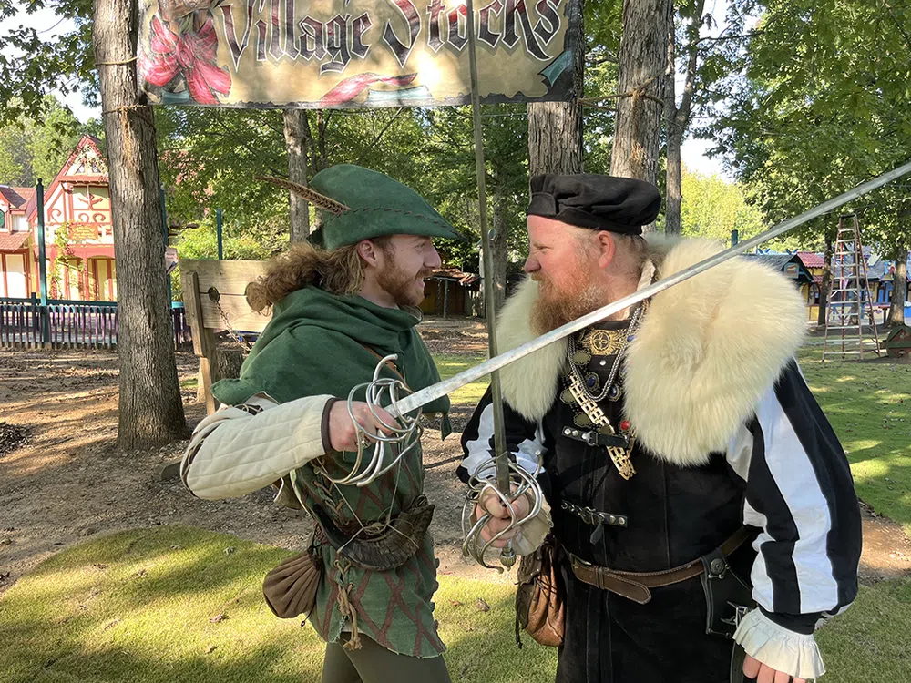 Robin Hood and the Sheriff of Nottingham trading words with blades crossed at the Georgia Renaissance Festival
