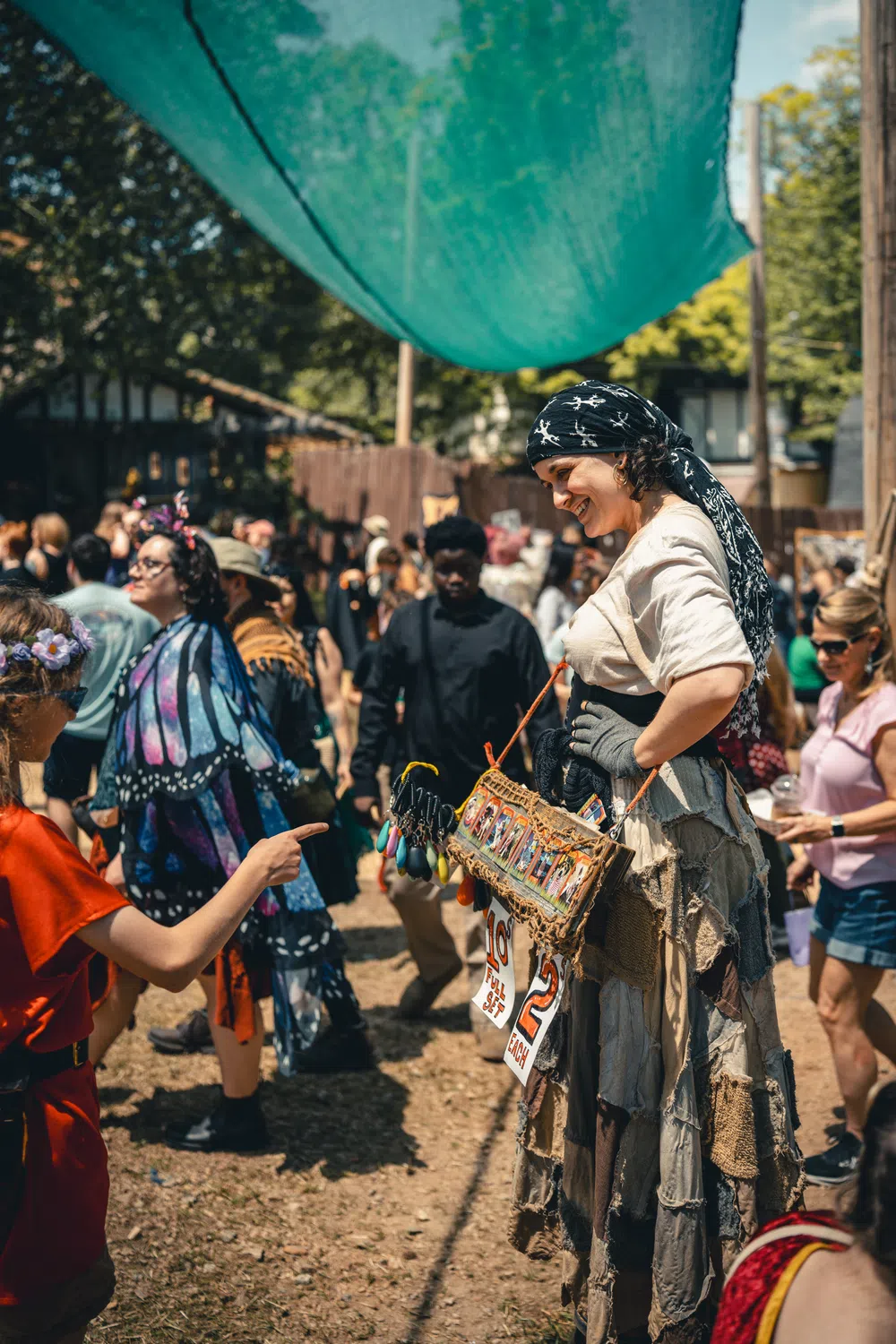 Guests browsing artisan craft sales along a lane in the Festival village.