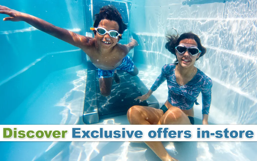 Two kids wearing goggles swimming underwater in a pool enjoying summer fun and play.