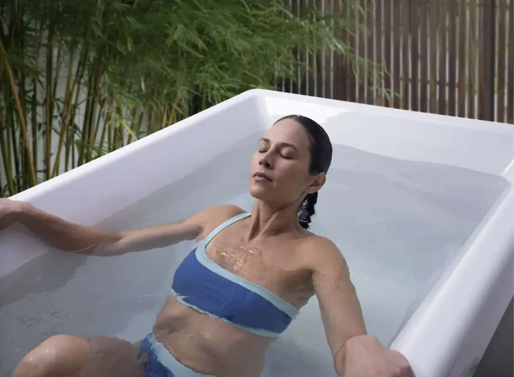 Woman relaxing in a spa tub during Georgia Spa Co. mid-year summer clearance sale promotion.