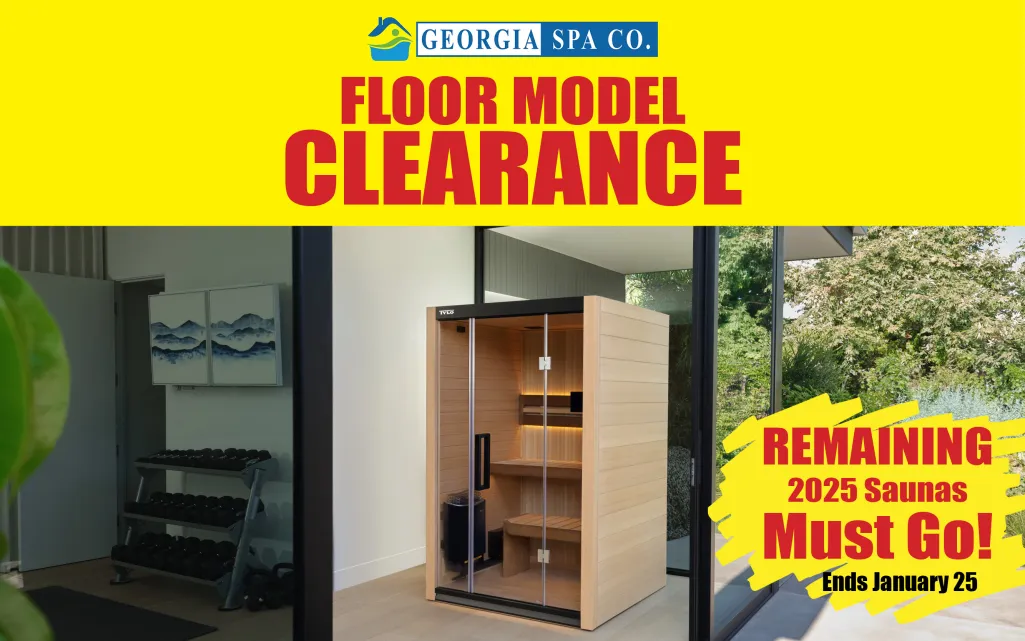 Modern wooden sauna on floor model clearance sale at Georgia Spa Co with gym weights and natural light background.