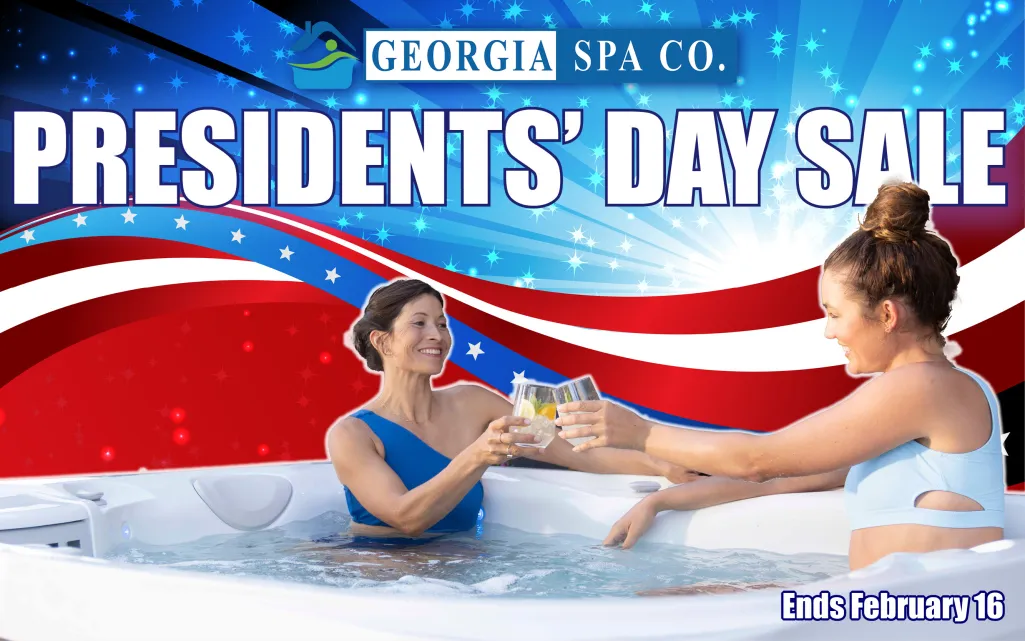 Two women enjoying drinks in a hot tub during Georgia Spa Co. Presidents' Day Sale with patriotic background.